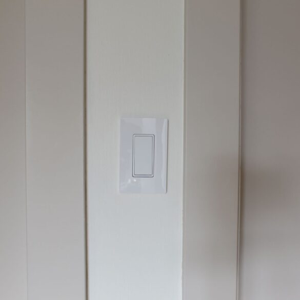 Beige trim and doors are on either side of a thin white wall
