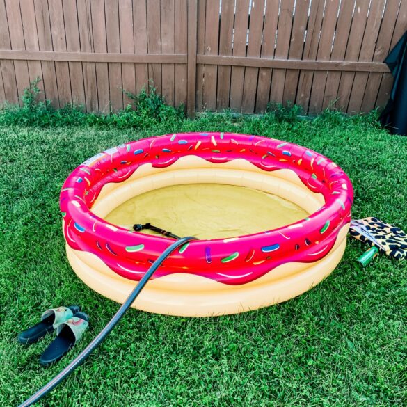 inflatable pool that looks like a donut is being filled